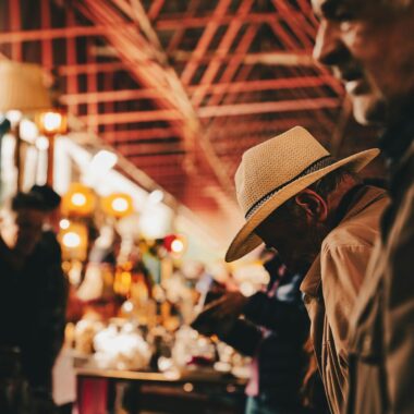 Two senior men at a bustling indoor market in Ankara, Türkiye.